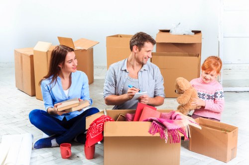 Flat removals team handling boxes and furniture in Camden