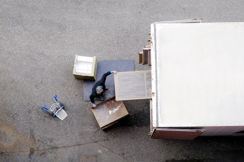 Removal crew handling business items in a busy Camden street