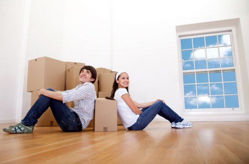 Loading furniture into a removals van near a Camden property