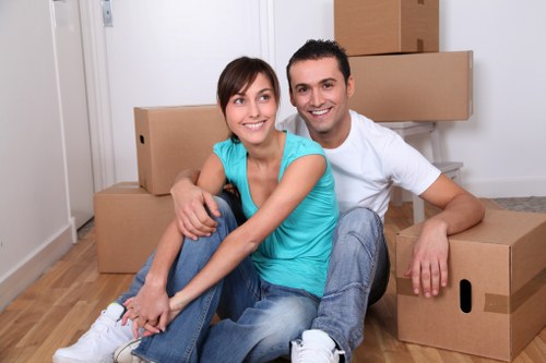 Local movers packing boxes in a Camden flat with stair access