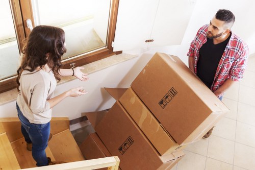 Professional movers handling furniture and boxes during a Camden home move